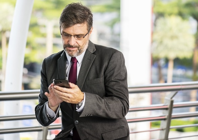 senior manager with his mobile phone