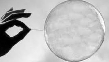 a man is ready to burst a bubble with a needle