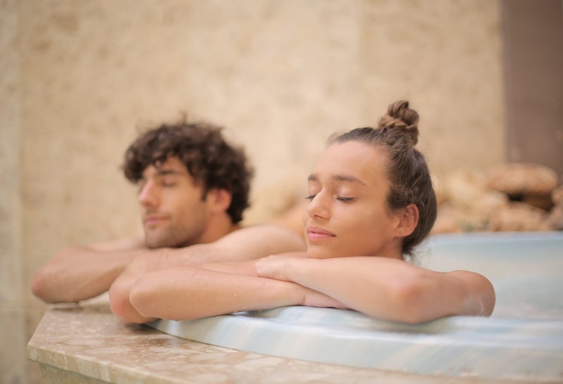 two young employees are enjoying a jacuzzi as a nice employees' benefit