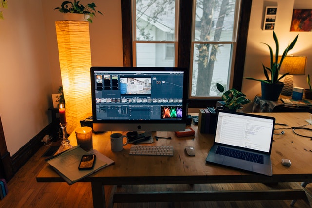 working table of a video editor, two monitors and other tools